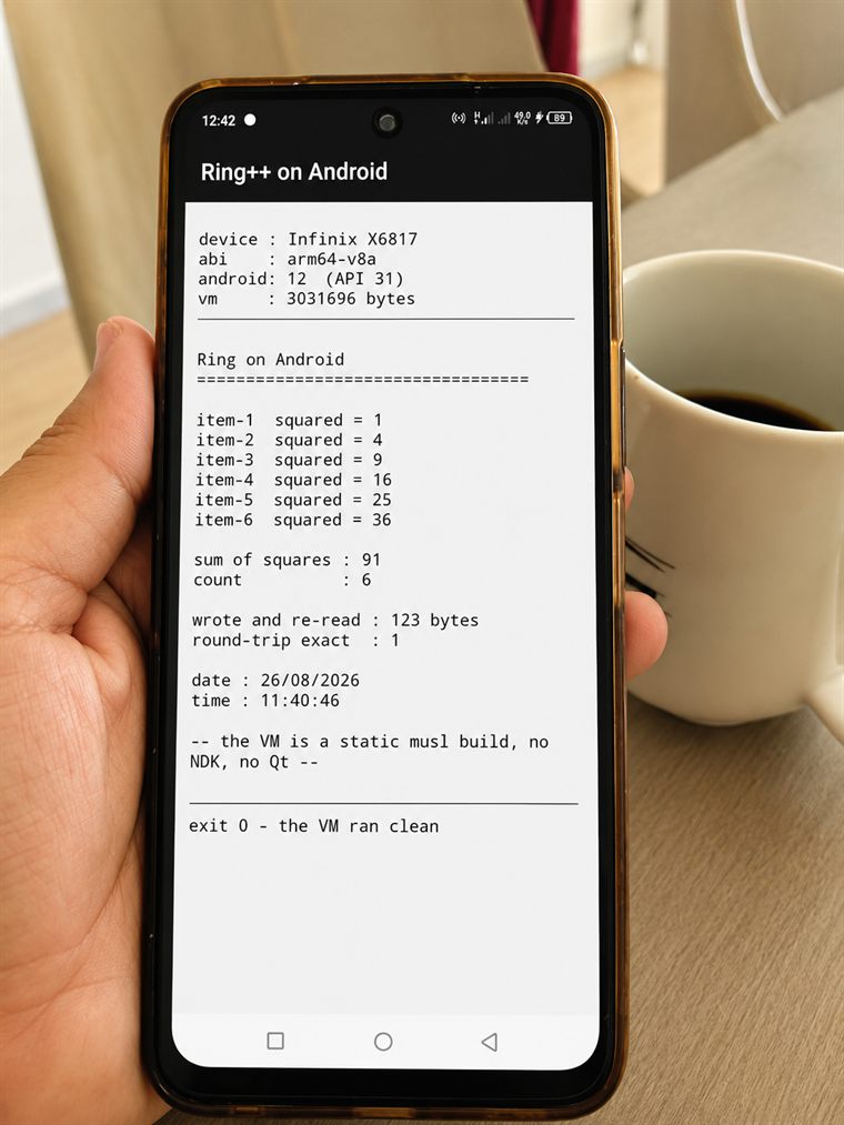 An Infinix phone held in a hand, showing a Ring program's output:
              device Infinix X6817, abi arm64-v8a, android 12 (API 31), a list of
              squared values, a sum, a file written and re-read at 123 bytes, and
              the line: exit 0 - the VM ran clean.
